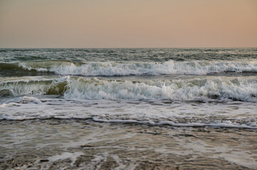waves on the black sea at sunset