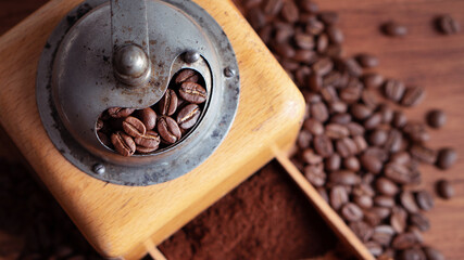 Vintage classic antique italy german hand manual ground coffee grinder powder of organic roasted espresso bean cinnamon star anise aroma in retro old wooden rustic homemade cafe shop barista style