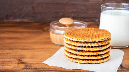 Traditional local authentic Dutch Netherlands sweet fresh homemade tasty stack brown golden waffle melt salted caramel honey syrup for dessert in cafe with hot warm coffee milk tea call Stroopwafel