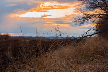 Sunset over a plowed field