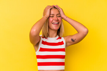 Young venezuelan woman isolated on yellow background laughs joyfully keeping hands on head. Happiness concept.