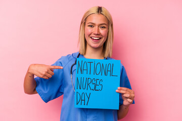 Fototapeta na wymiar Young nurse woman holding a international nurses woman banner isolated on pink background