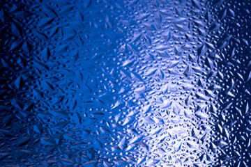 Abstract background of corrugated blue glass.Glass background
