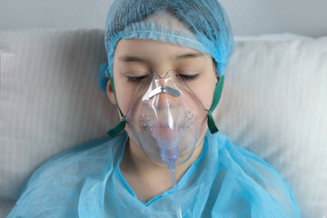 little patient in shirt, child, boy lies, facial oxygen mask, concept of medical care,...