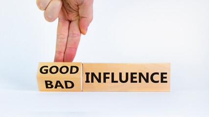Good or bad influence symbol. Businessman turns cubes and changed words 'bad influence' to 'good...