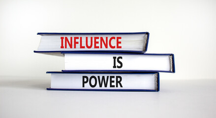 Influence is power symbol. Books with words 'Influence is power'. Beautiful white background....