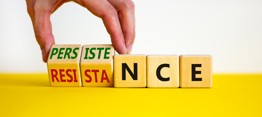 Persistence or resistance symbol. Businessman turns cubes, changes the word 'resistance' to...
