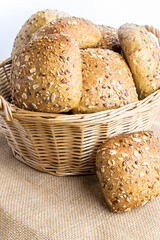 Rye bread. Bakery with crusty loaves and crumbs. Fresh loaf of rustic traditional bread with wheat grain ear or rye spike plant on natural cotton background. Healthy Food concept.