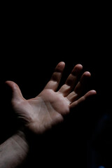 White male hand in the dark