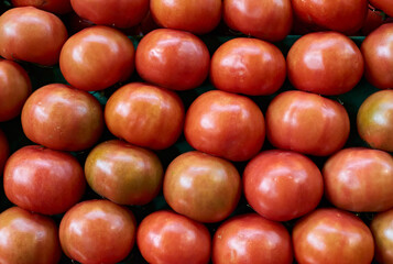 A stock of ripe tomatoes, vegetable background