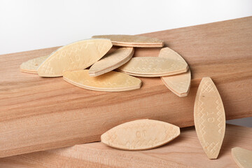 Biscuit joint and wood pieces isolated on white background, Woodworking