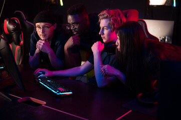 Players of the esports team gathered together in the computer club and watch the stream from the...