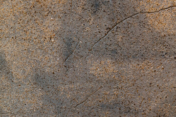 Rough concrete wall with a crack
