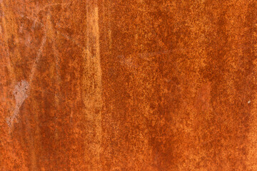 Smooth, slightly rough weathered and rusted orange-red colors surface with rust runs and rust spots. Detailed closeup Rusted metal sheet texture