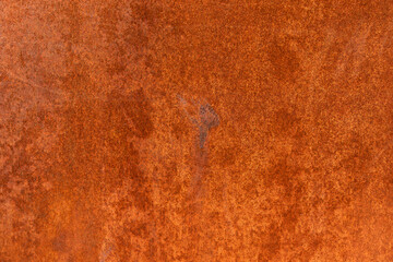 Smooth, slightly rough weathered and rusted orange-red colors surface with rust runs and rust spots. Detailed closeup Rusted metal sheet texture