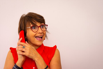 Mujer vestida de rojo con gafas rojas y telefono rojo