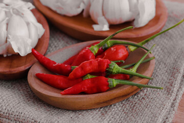 cayenne pepper and garlic on a coconut wood plate