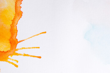 An abstract hand drawn orange watercolor splash
