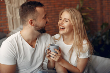 Couple sitting on a bed in a room