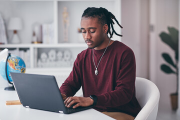 young african american man typing on laptop keyboard, student searching information, it remote work