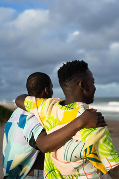 Young black men looking at the ocean