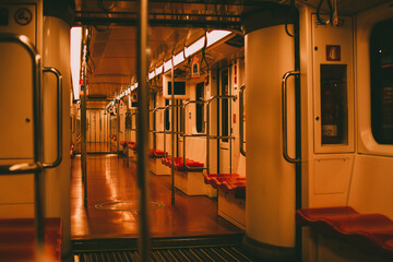 Shallow focus inside the empty metro illuminated with dim lights