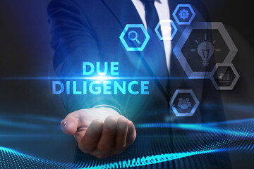 Business, Technology, Internet and network concept. Young businessman working on a virtual screen of the future and sees the inscription: Due diligence