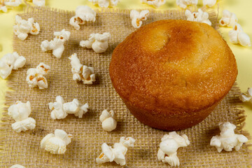 orange cake surrounded by popcorn spread on the table ...