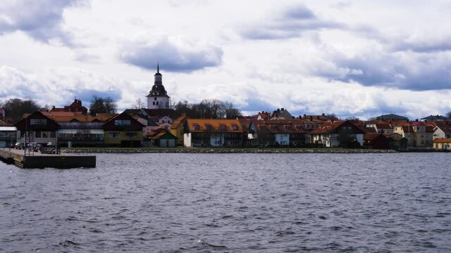 Waterfront Houses With Tower Of St. Gertrude ChurchIn Coastal Town In City Of Vastervik, Sweden. - wide panning left