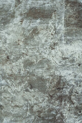 Background texture. Aged concrete surface with white paint residues. Top view. Copy space. Vertical