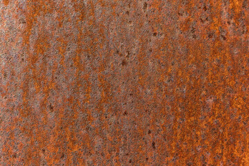 Smooth, slightly rough weathered and rusted orange-red colors surface with rust runs and rust spots. Detailed closeup Rusted metal sheet texture
