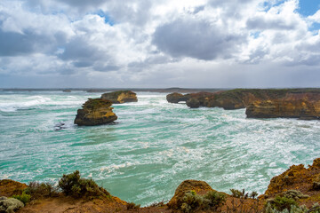 Fototapeta premium Beautiful ancient rock formations with breaking waves on the Great Ocean Road, Victoria, Australia