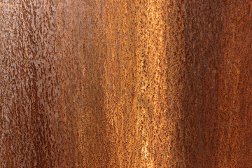 Smooth, slightly rough weathered and rusted orange-red colors surface with rust runs and rust spots. Detailed closeup Rusted metal sheet texture