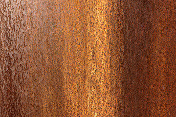 Smooth, slightly rough weathered and rusted orange-red colors surface with rust runs and rust spots. Detailed closeup Rusted metal sheet texture
