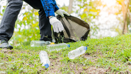 Collect plastic bottles on the grass in the park clean up the woods help environmental charity waste collection ideas