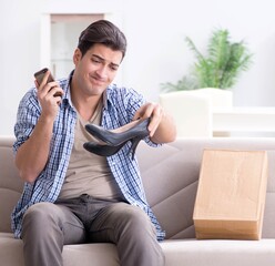 Man receiving wrong parcel with female woman shoes