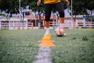 Latin woman dribbling with soccer ball
