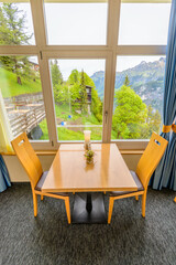 Modern dining room in luxury restaurant with fantastic swiss alps mountain view.