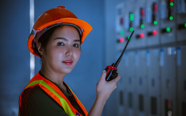 Portrait engineer pose checking and inspecting with radio communication at MDB panel .she working...
