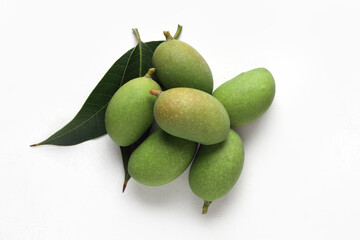 Tender mango on a white base for Indian style mango pickle.