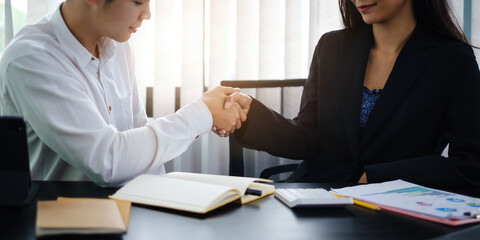 Finishing up meeting. Business and partners handshaking and agree make big project.