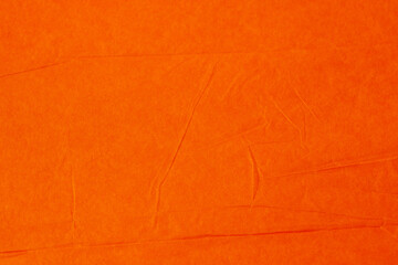 texture background made of empty crumpled wrinkled tissue paper in orange color.