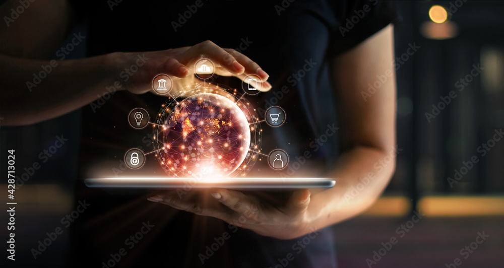 Fototapete Man holding virtual globe with marketing network connecting icons on tablet. Innovation technology develop sustainable future service and smart solution in global business.