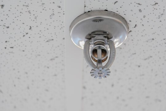 ceiling sprinkler head to extinguish fire in an office