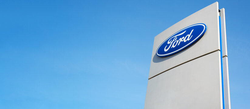 Ford American car company sign, clear blue sky background outside. Banner, copy space, blank space for your text.
