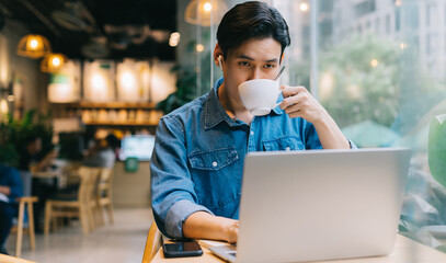 Asian man working at cafe on weekend