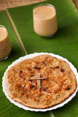 Pesaha Appam, Bread ,Paal religious Christian food on Maundy Thursday, Happy, Good Friday with rice flour Kerala India Sri Lanka. Palm Sunday, Easter Sunday. Top view cross of coconut palm leaf 