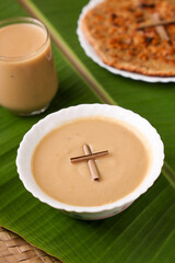 Pesaha Paal Appam, Bread religious Christian food on Maundy Thursday, Happy, Good Friday with rice flour Kerala India Sri Lanka. Palm Sunday, Easter Sunday. Top view cross of coconut palm leaf 