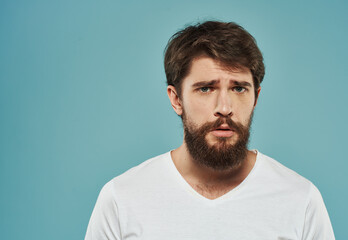 Portrait of a handsome man on a blue background with a cropped beard look