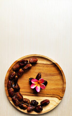 Cressent moon shaped dates on a wooden plate. Iftar party concept
